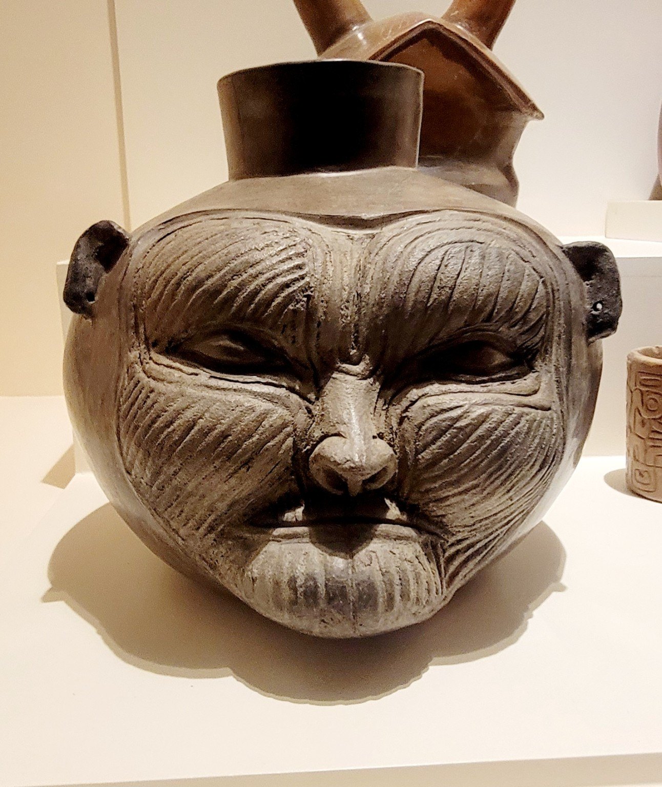 Ancient ceramic vessel with face