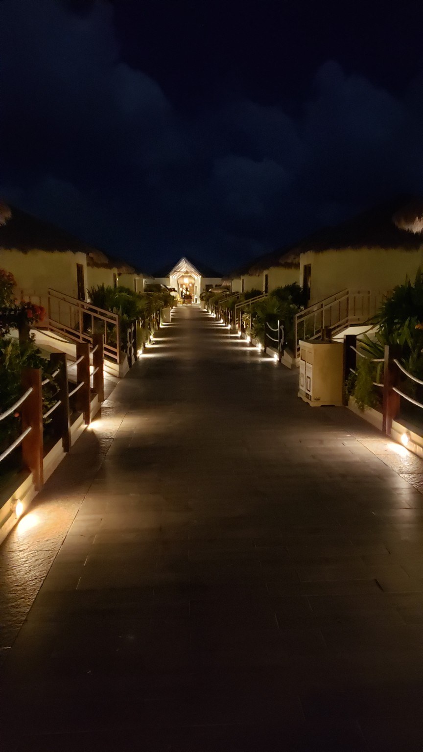 Night walkway with resort lights at El Dorado Maroma
