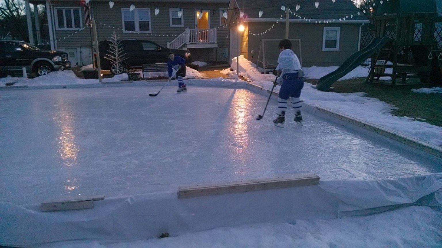 First skate on the backyard rink under evening lights