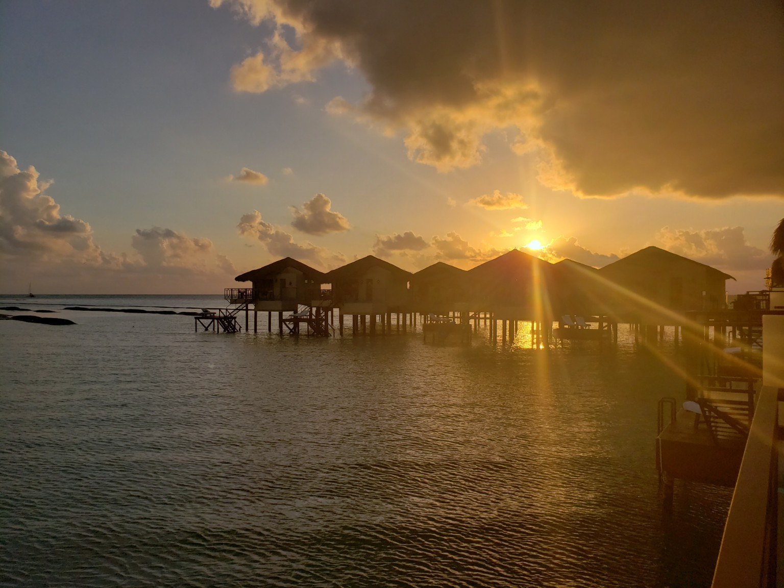Sunset over the overwater bungalows at El Dorado Maroma, Mexico