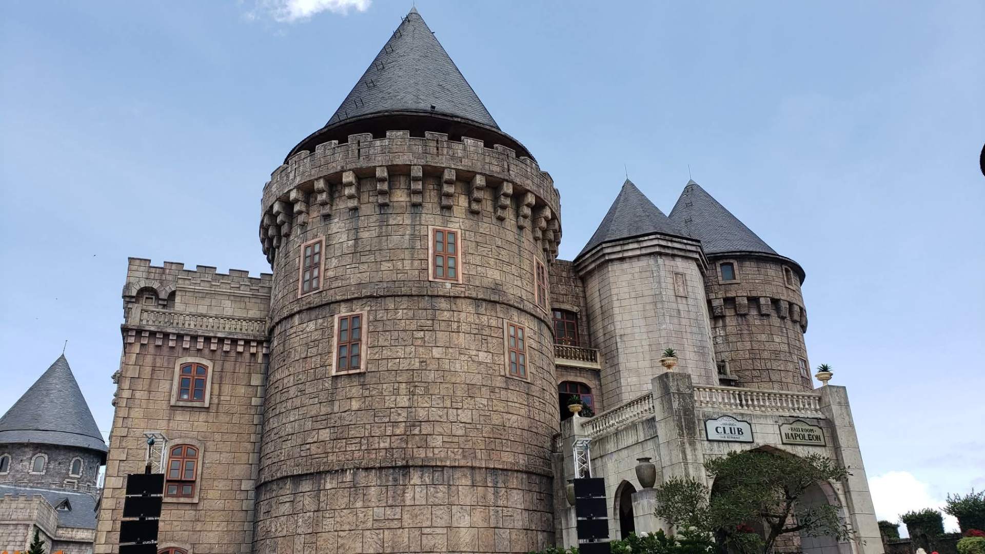 Stone castle turret with conical slate roof at Ba Na Hills