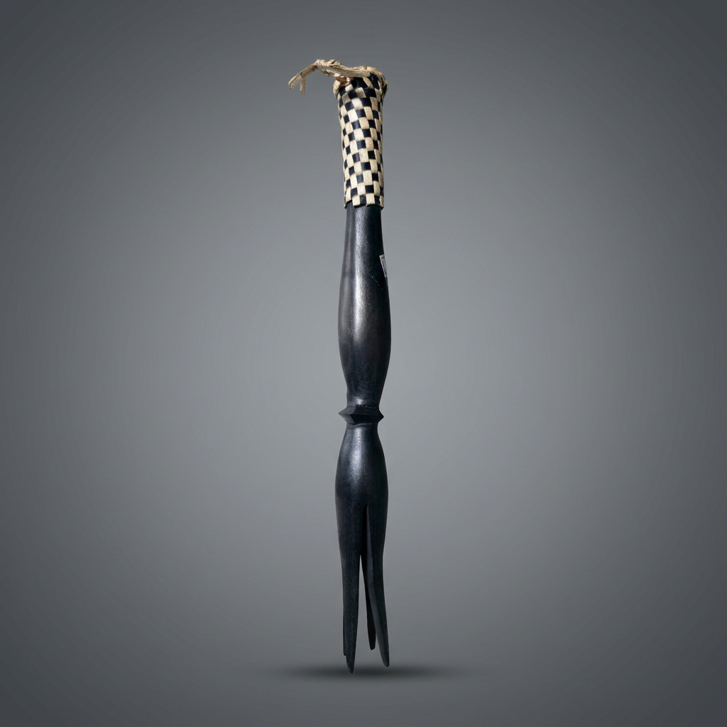 Fijian carved wooden cannibal fork with three tines and woven pandanus binding at the handle