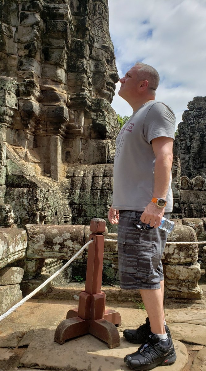 A close-up of the serene smiling stone faces of Bayon Temple