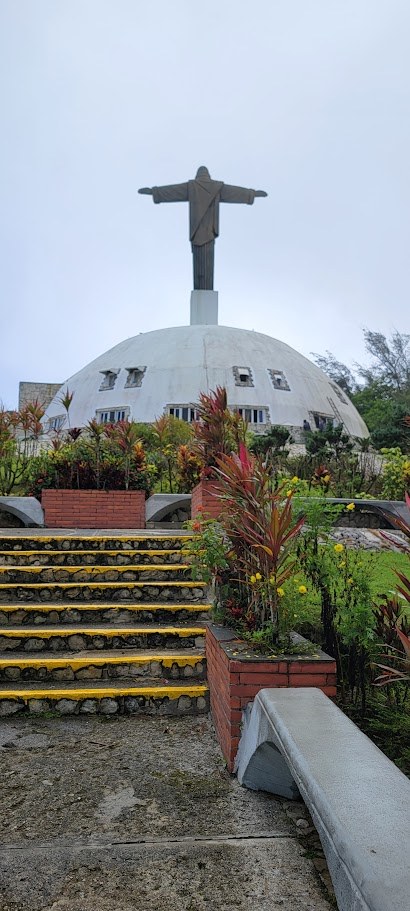 The steps up to the Christ statue on Mount Isabel de Torres, wrapped in tropical gardens and mountain mist.