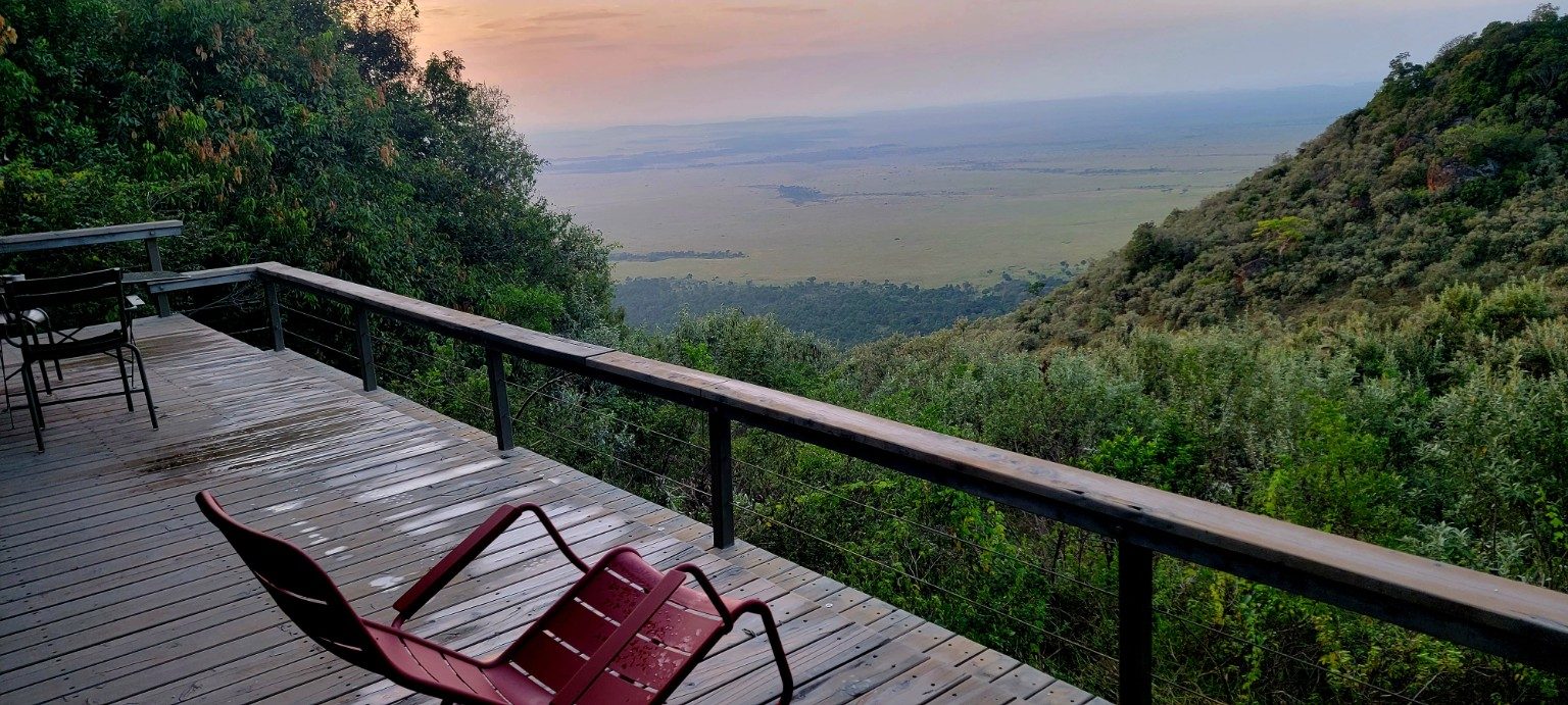 View from a lodge deck looking out over the Mara plains