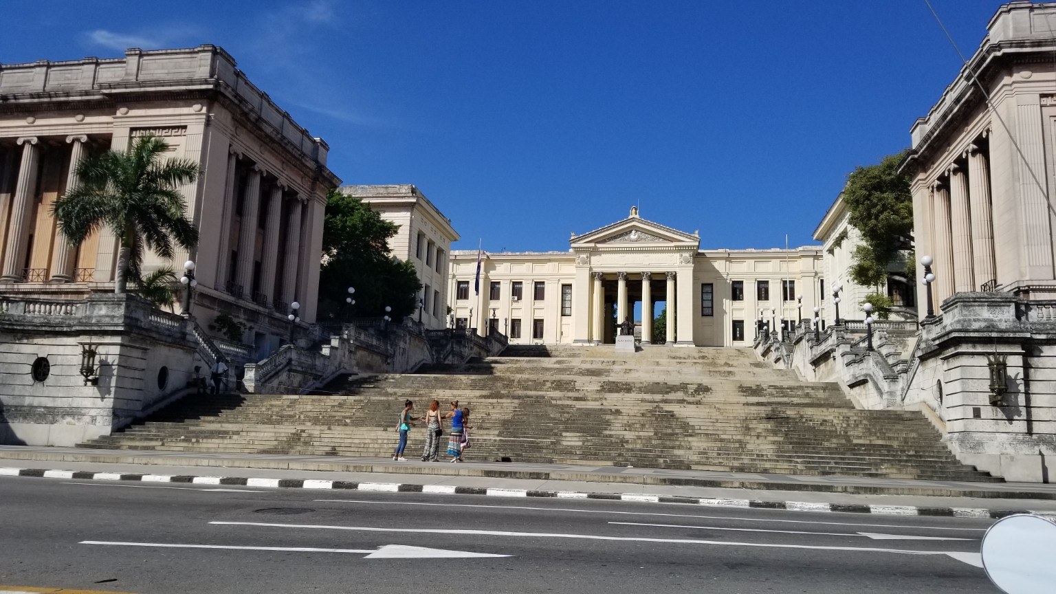 Neoclassical columns and grand staircase of the University of Havana under blue sky
