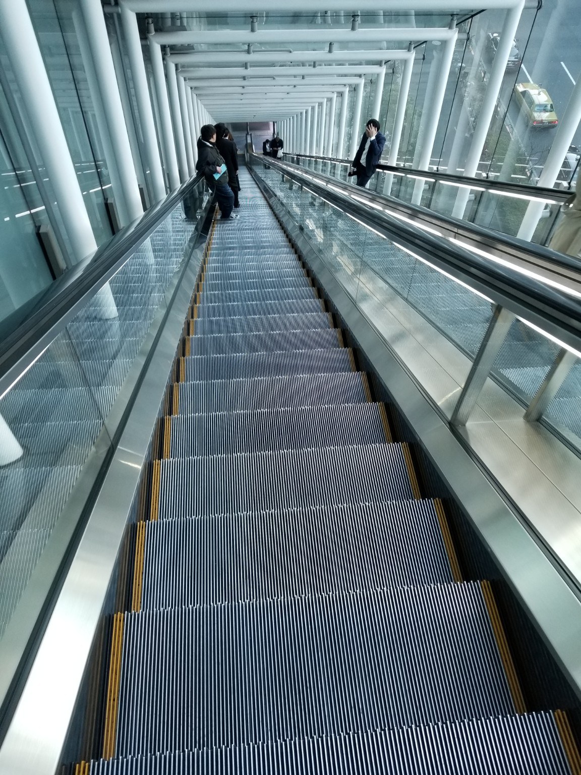Tokyo's modern architecture seen from a long escalator