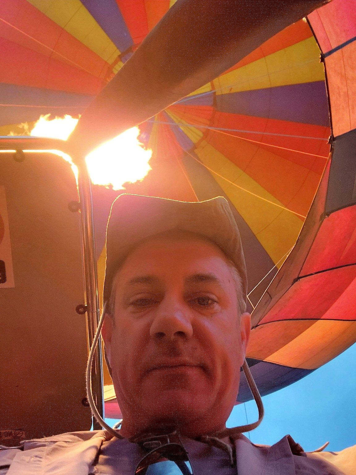 View up into a hot-air balloon canopy with the burner firing