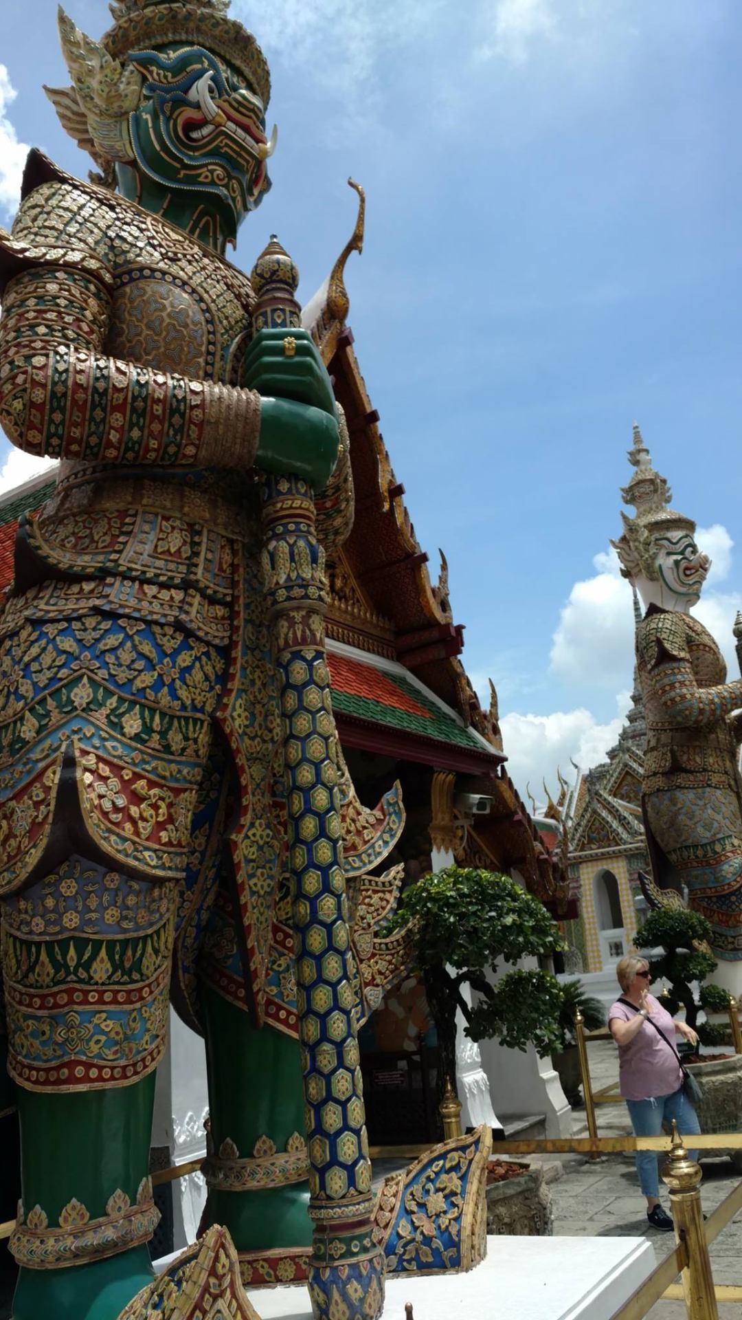 Towering yaksha demon guardian statues outside a temple at the Grand Palace