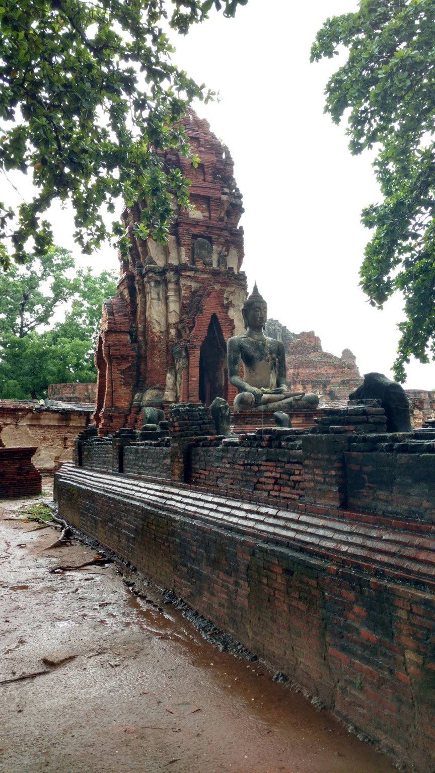 Red brick ruins at Ayutthaya after rain, quiet and atmospheric