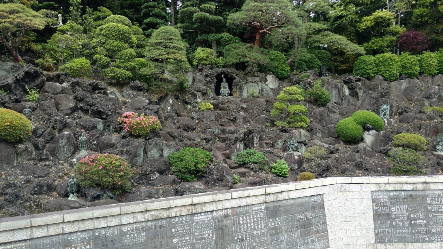 Stone markers, greenery, and temple grounds at Naritasan