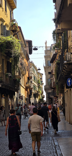 Verona street scene with balconies and shoppers