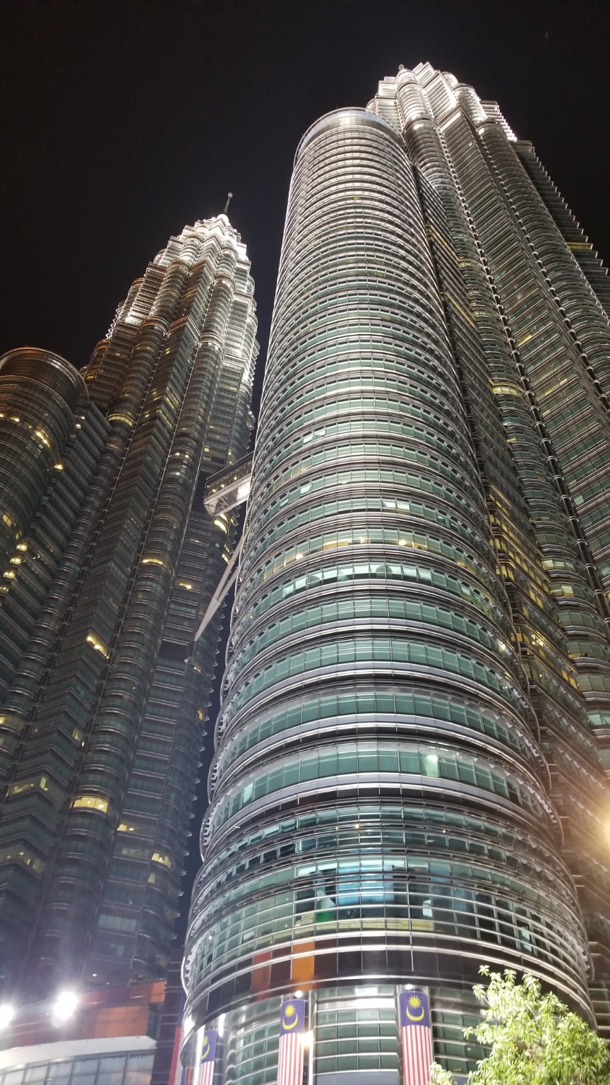 The Petronas Twin Towers and surrounding KLCC skyline illuminated at night