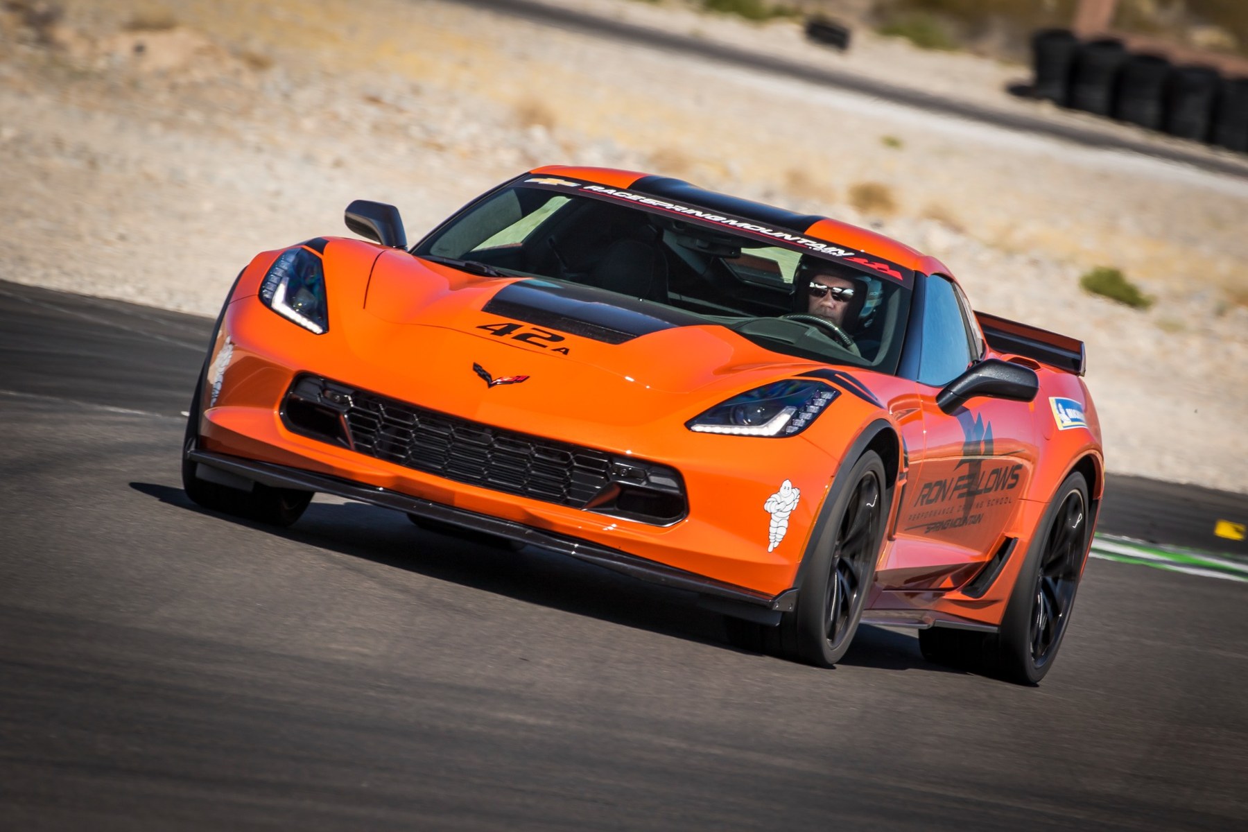 Orange Corvette exiting a turn at the Ron Fellows racing school