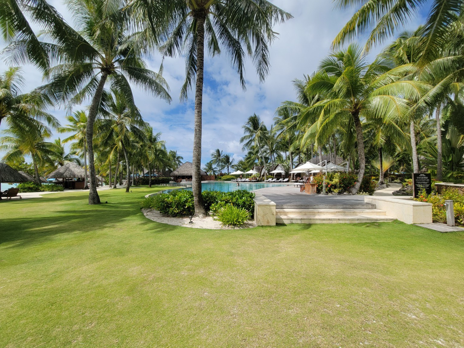 Palm trees and soft lawns on the grounds of the Four Seasons Bora Bora