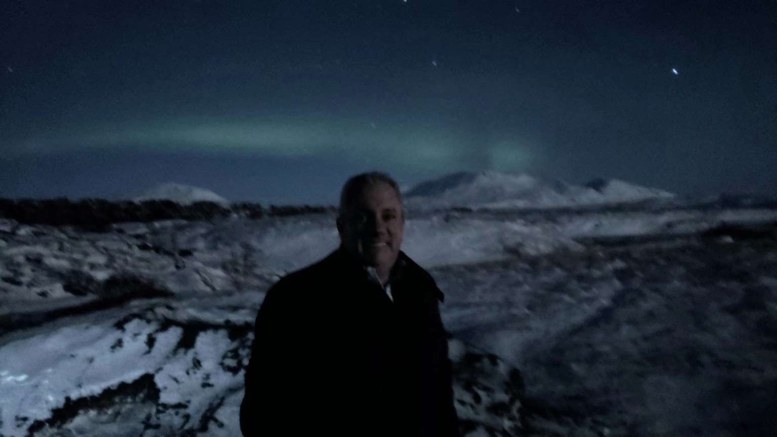 Geyser eruption beneath moody Icelandic skies