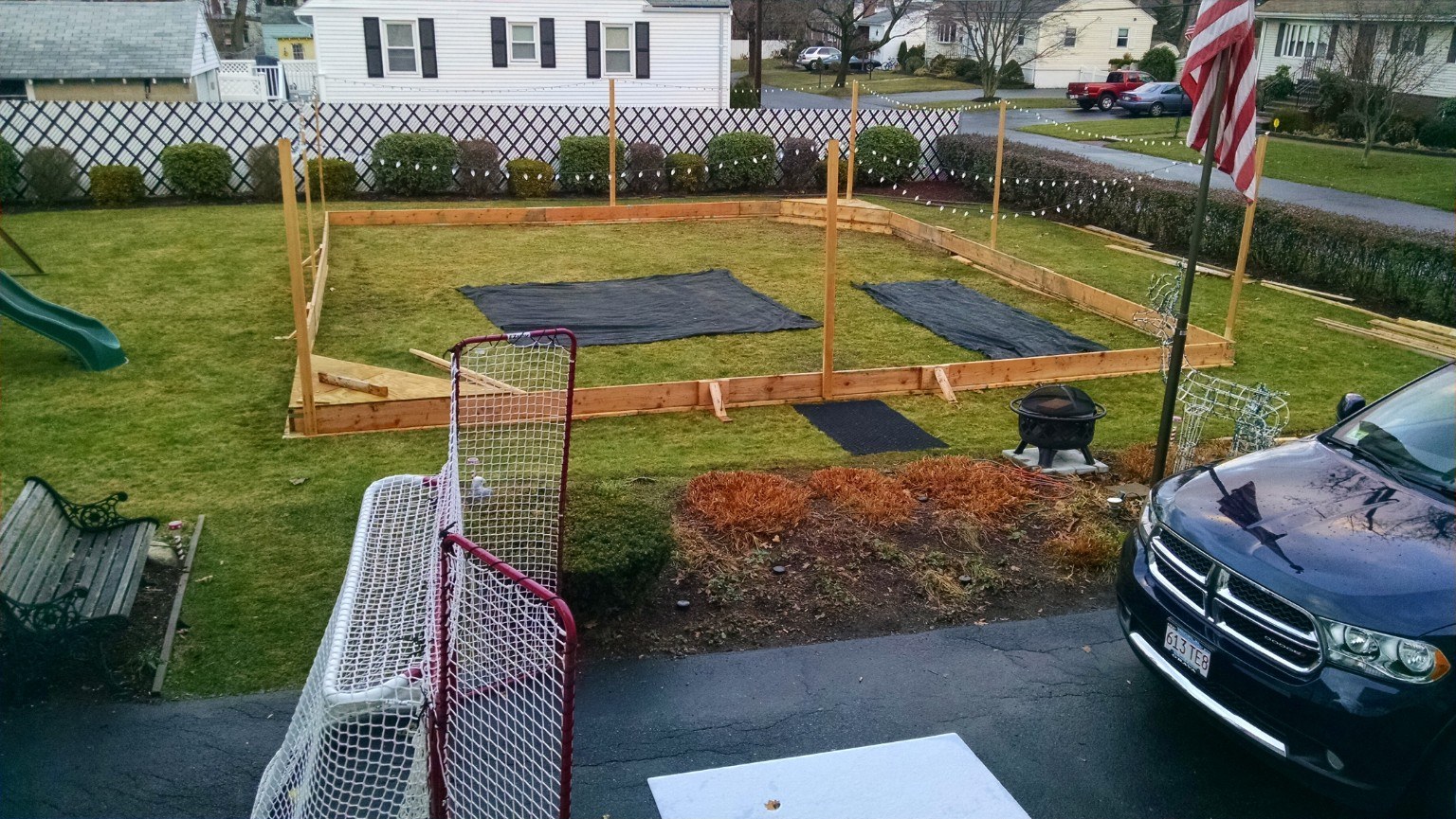 Wooden frame for backyard hockey rink under construction