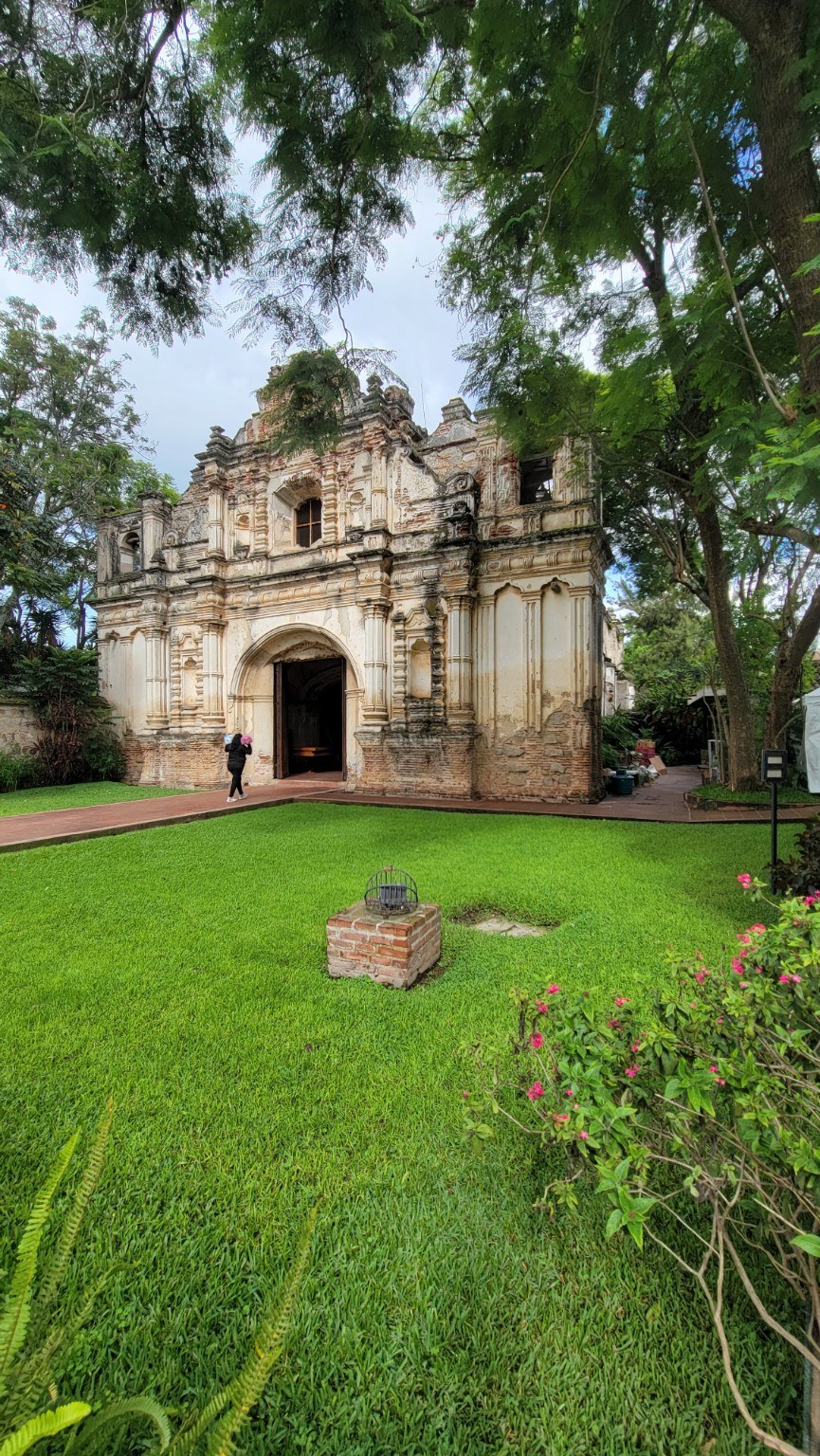 Roofless colonial ruins of San José el Viejo in a green Antigua courtyard