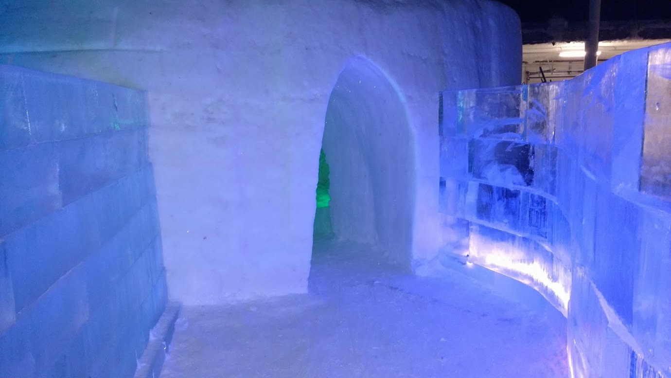 Ice walls and igloo forms lit in blue inside Winter World