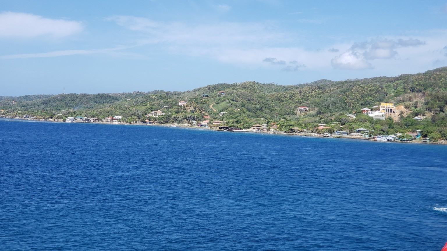 St. Kitts coastline with hillside homes and deep blue water