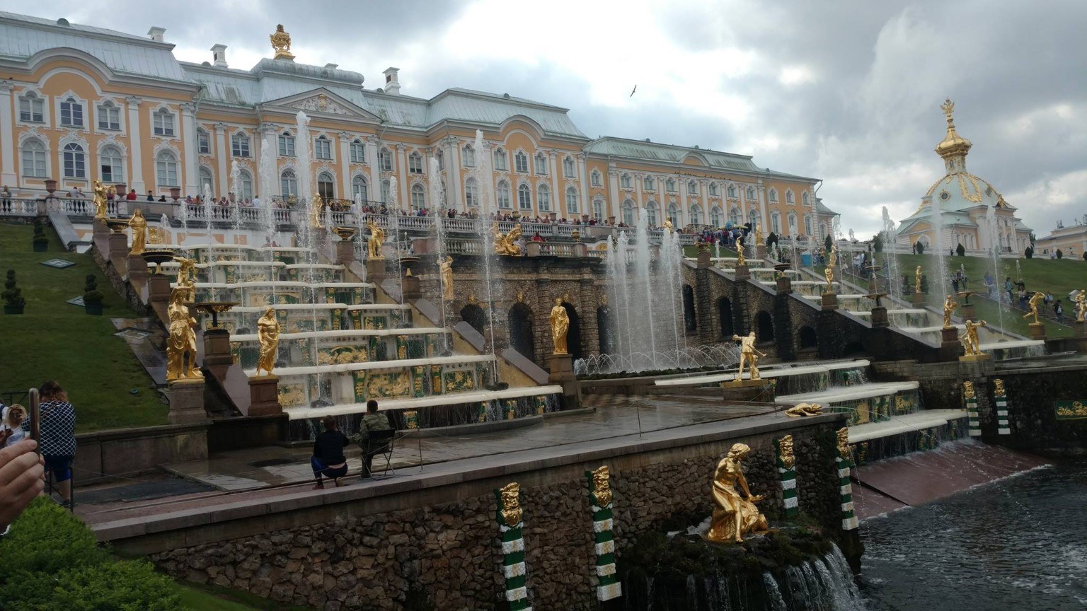 Peterhof Palace and the Grand Cascade with gilded statues under storm clouds near St. Petersburg, Russia