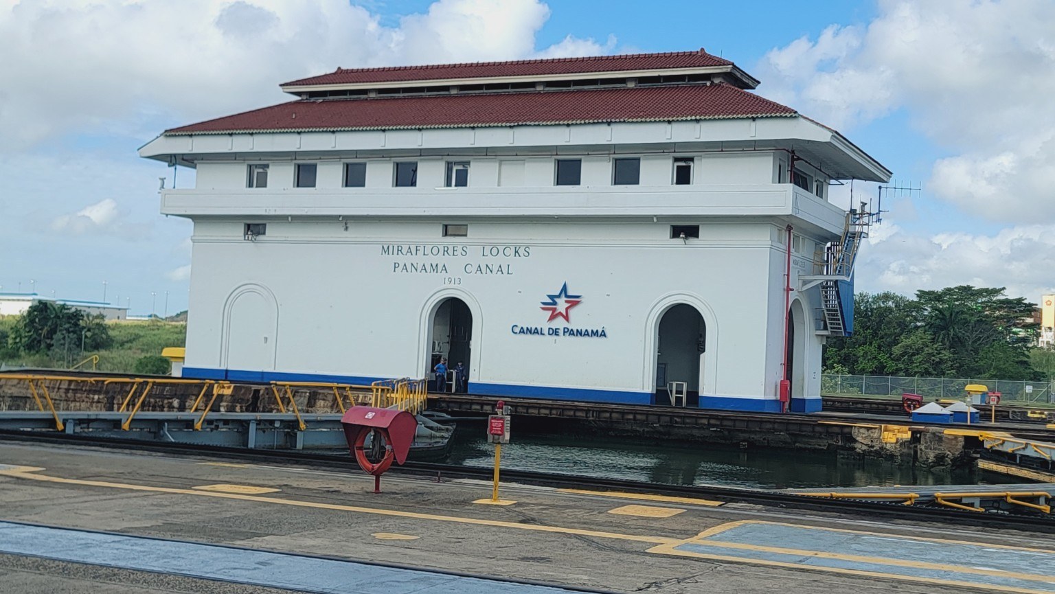 Miraflores Locks control house from 1913 with the modern 'Canal de Panamá' star logo