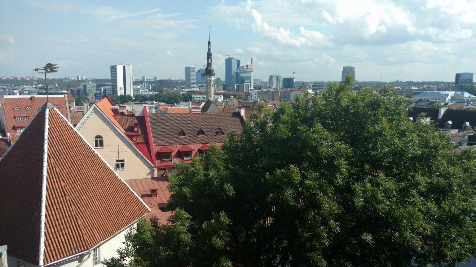 Tallinn's red roofs and church spires with the newer skyline beyond