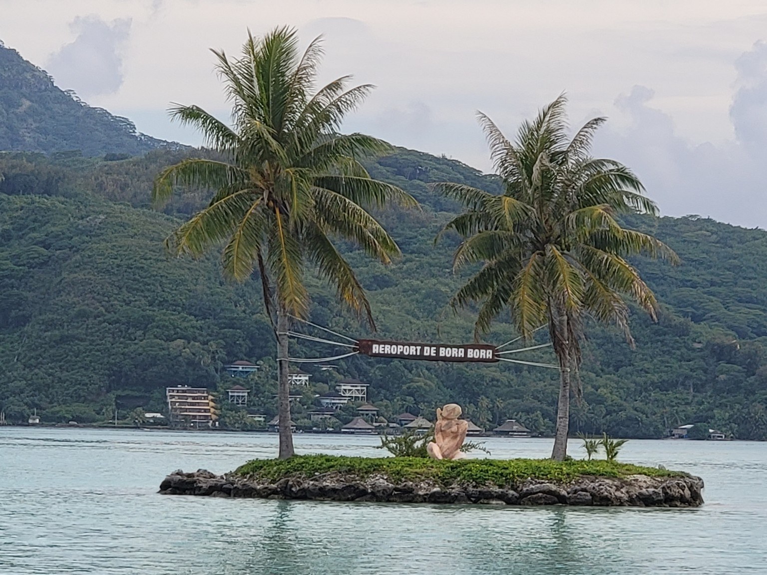 Bora Bora airport sign on a small motu surrounded by turquoise lagoon