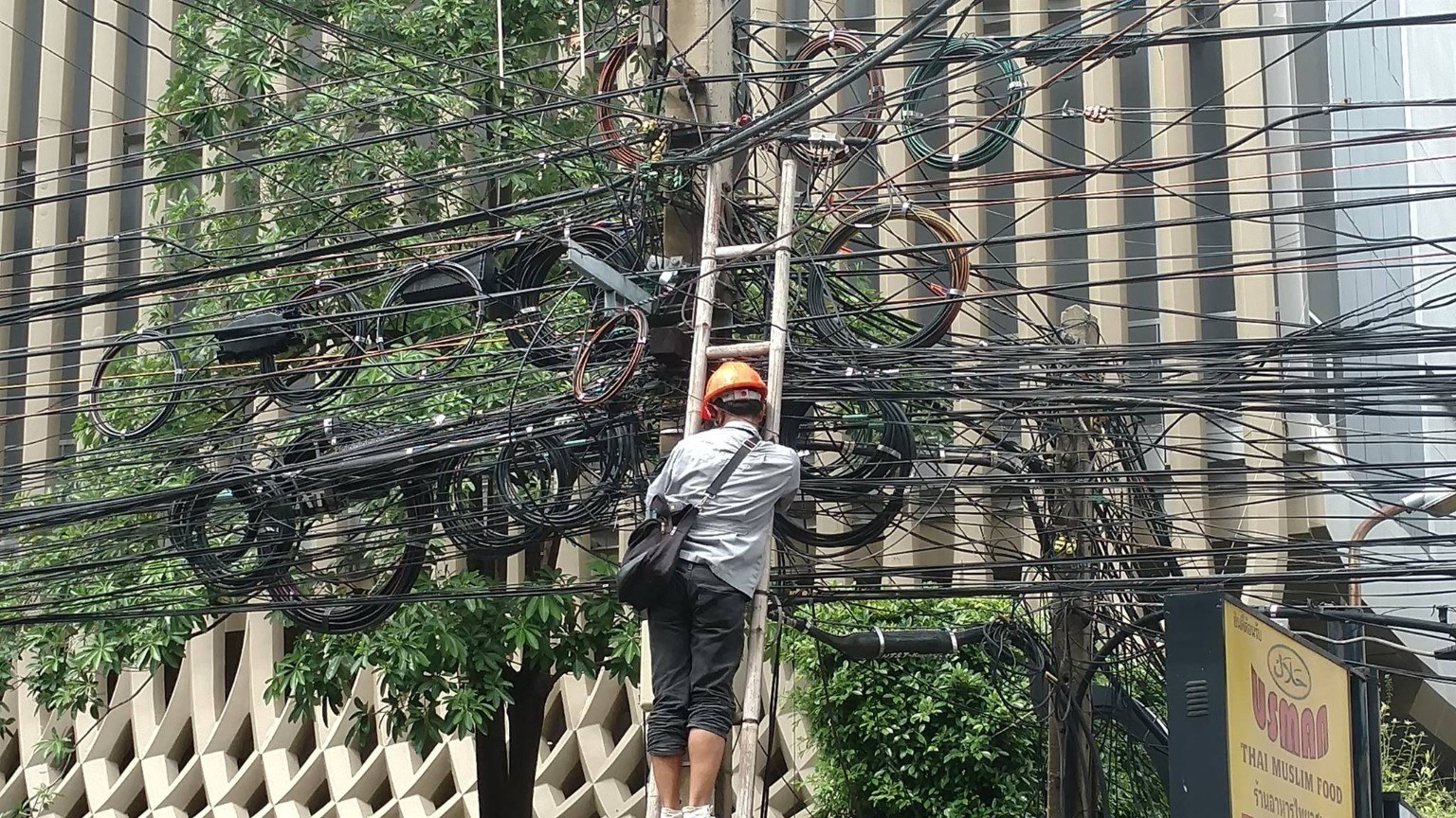 Tangled bundles of street wiring on a Bangkok pole