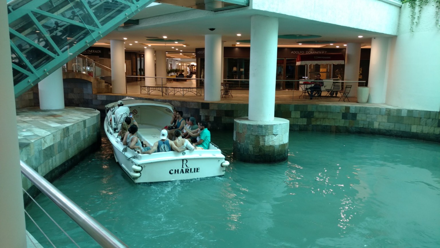 A boat gliding through the shopping district of Oranjestad, Aruba
