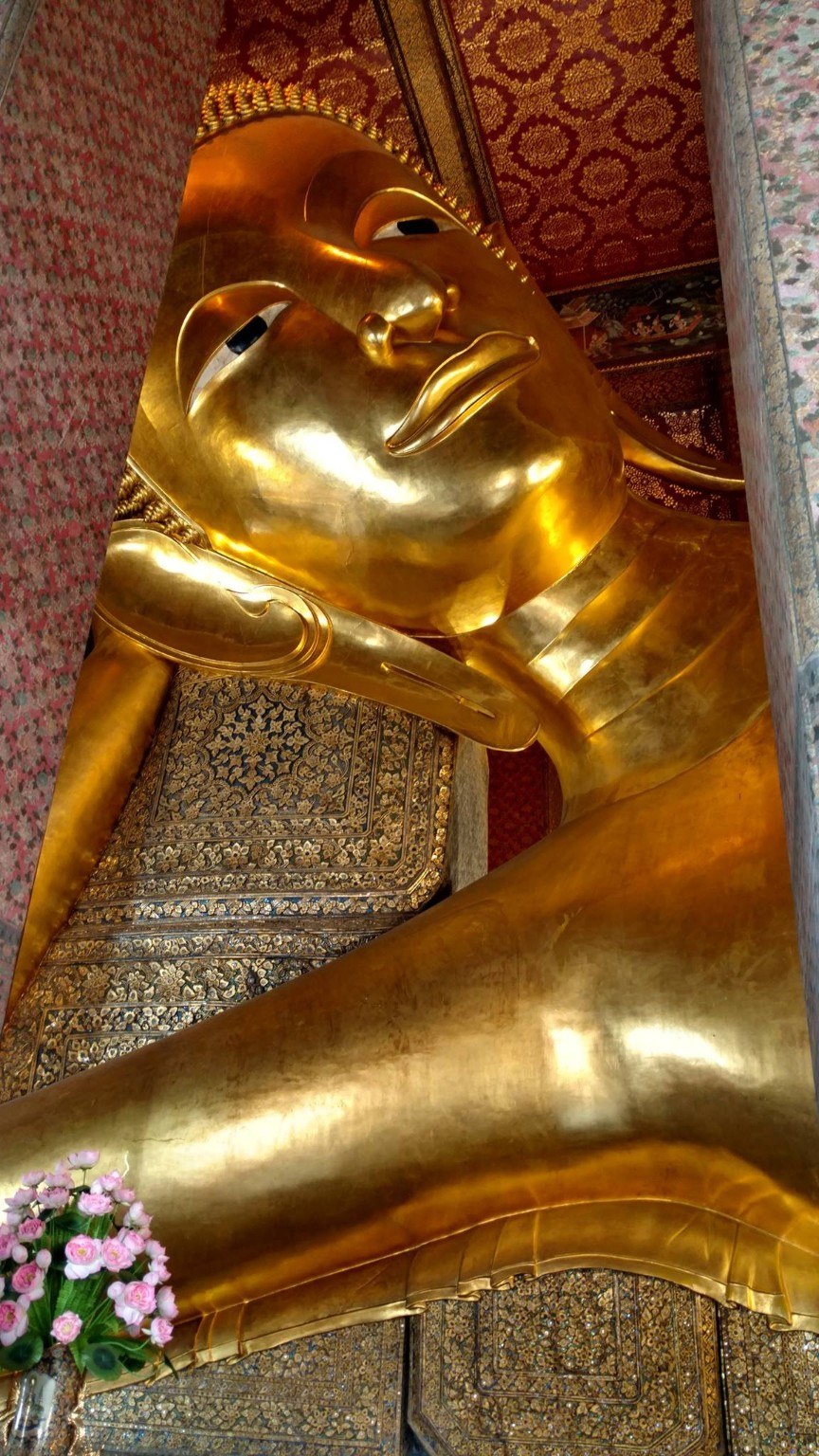 Close view of the Reclining Buddha's serene golden face