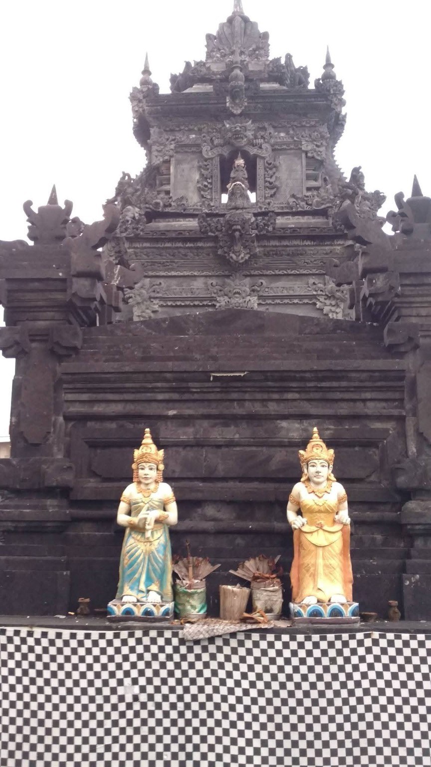 Temple guardians at the base of a dark stone shrine