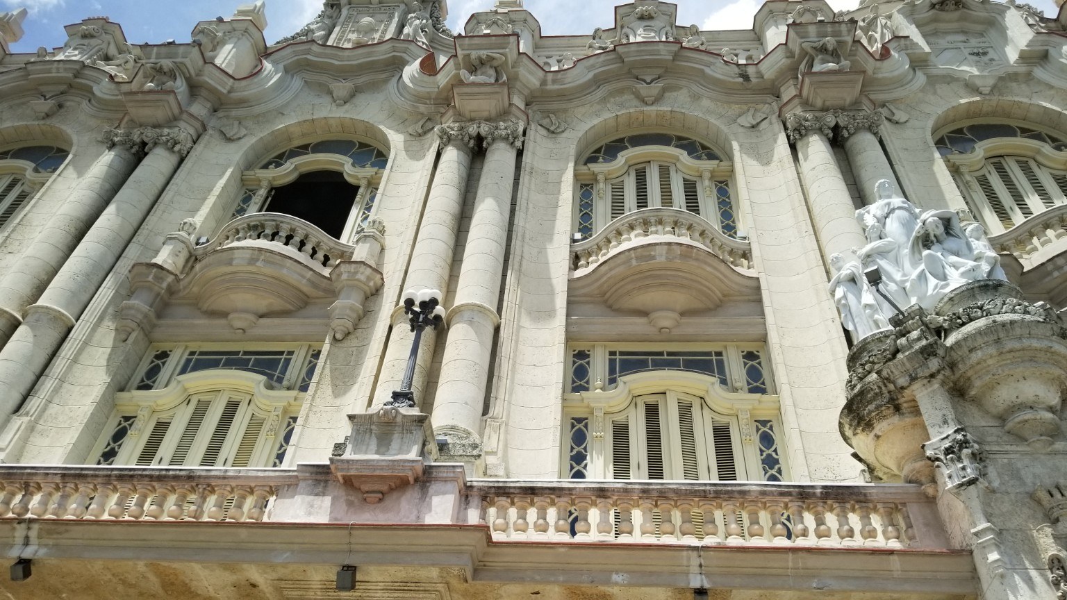 Ornate baroque facade of the Gran Teatro de La Habana with marble statues against the sky