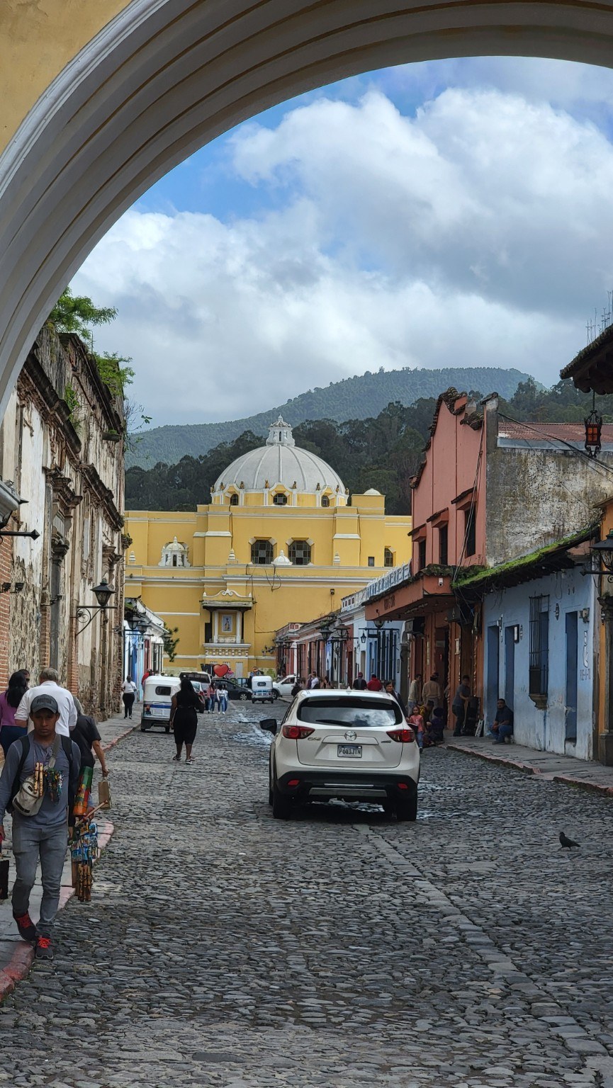 View through the Arco de Santa Catalina toward La Merced and a volcano in Antigua