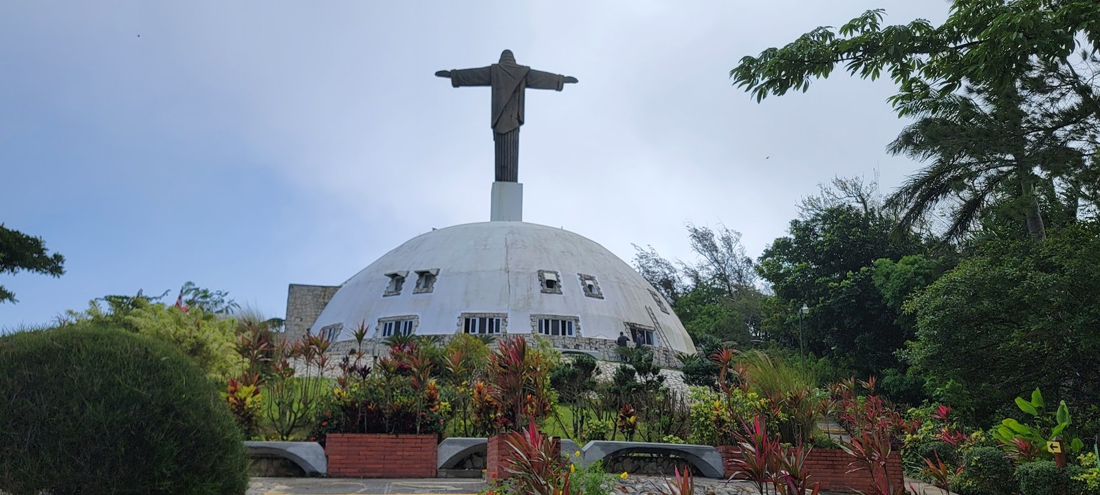 The Christ statue rising over the dome at Mount Isabel de Torres, Puerto Plata's mountain landmark.