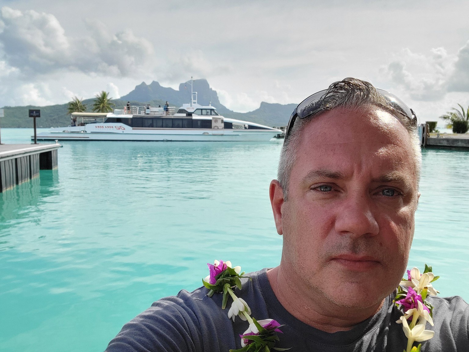 Selfie in Bora Bora wearing a flower lei with the lagoon in the background