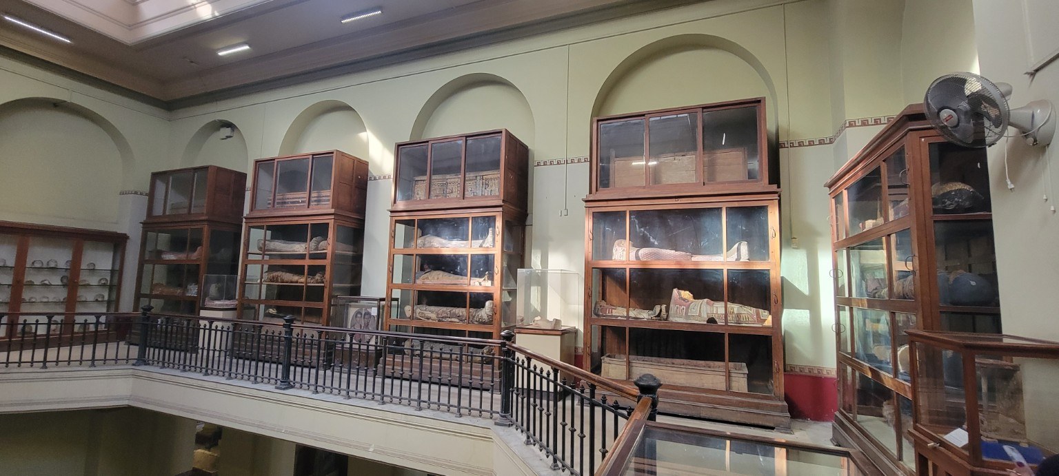 Long gallery of glass cases filled with ancient Egyptian artifacts