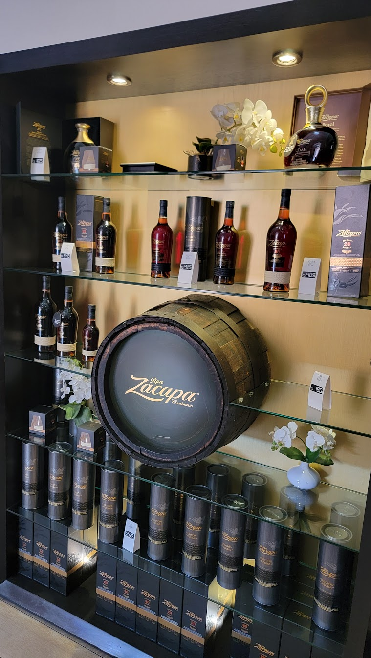 Ron Zacapa bottles and barrel display at La Casa del Ron in Antigua, Guatemala