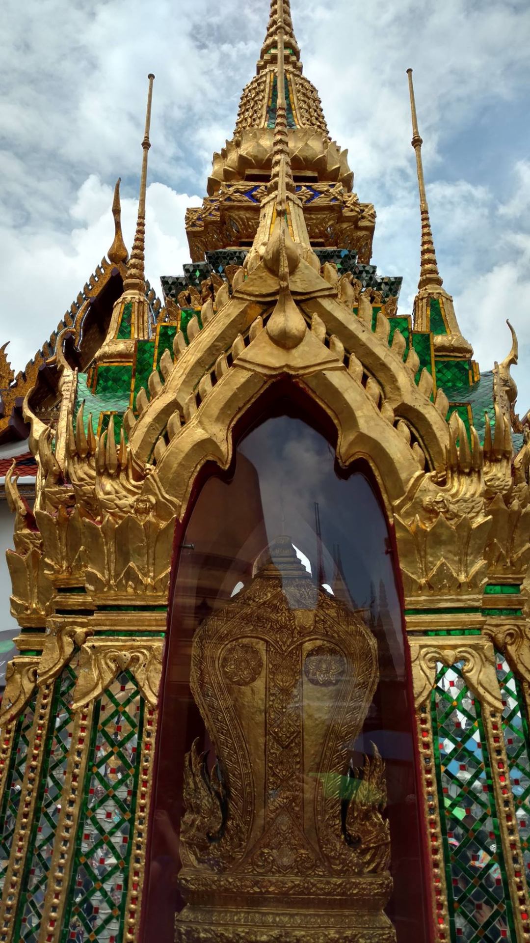 Ornate gold pavilion with mirrored mosaic facade at the Grand Palace