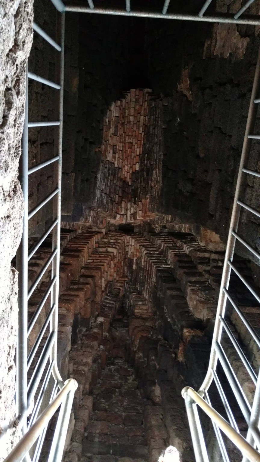 Shadowed descent into the crypt at Wat Ratchaburana