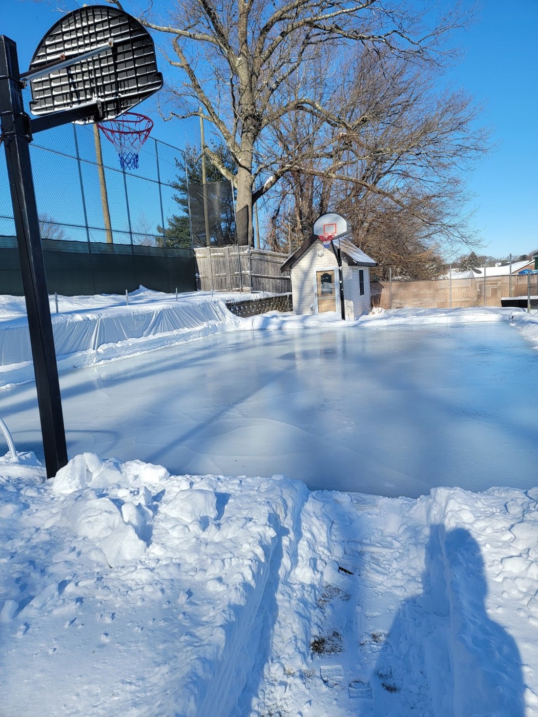 Basketball hoops above the iced-over court