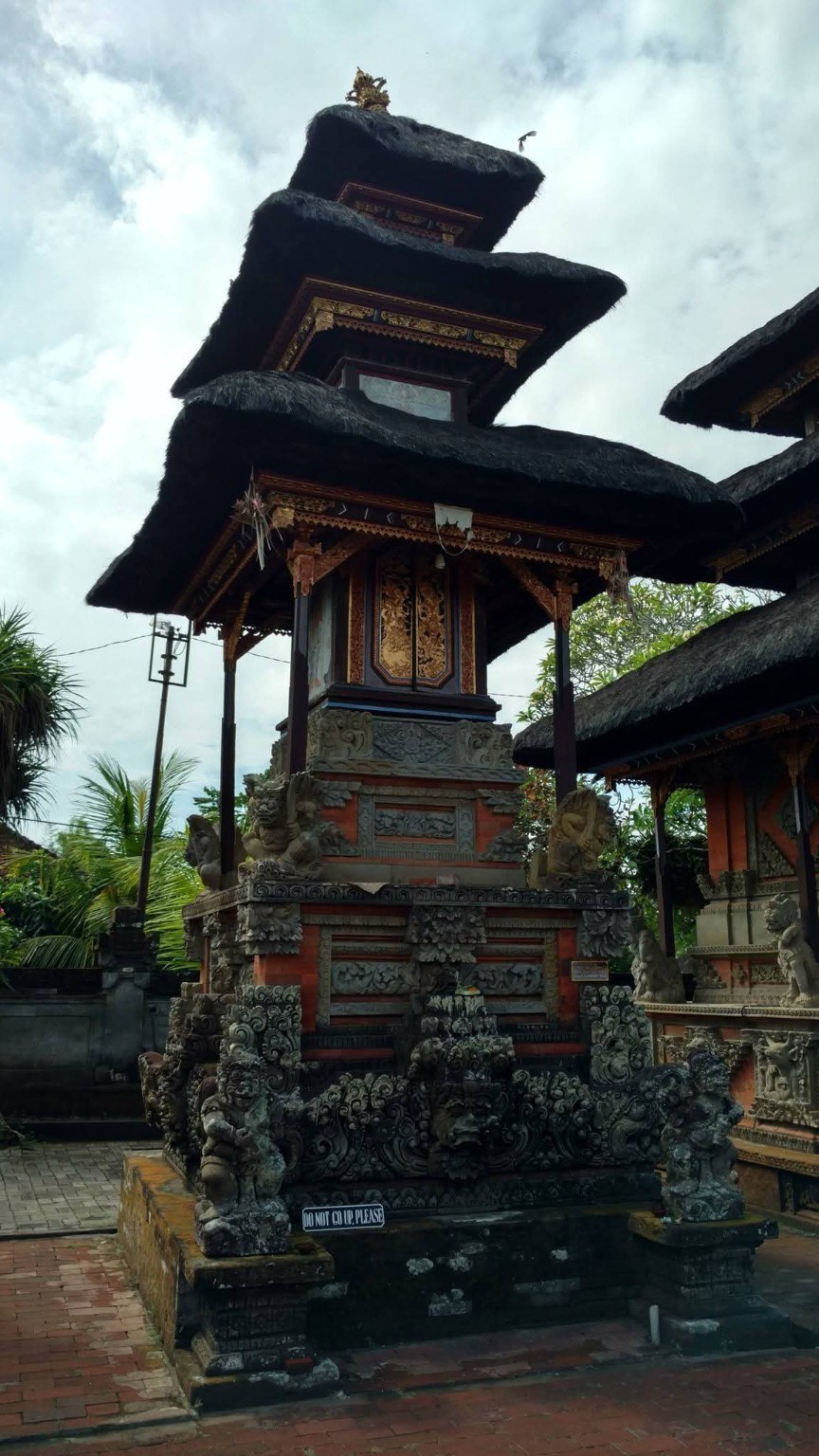 A thatched temple tower, layered like a small mountain of architecture