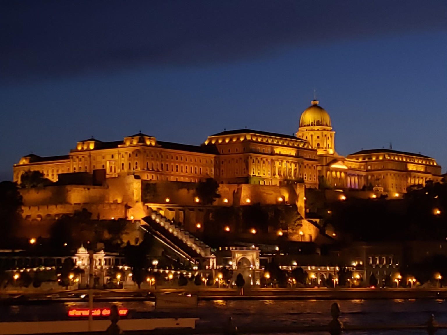 Buda Castle lit warmly against the night sky