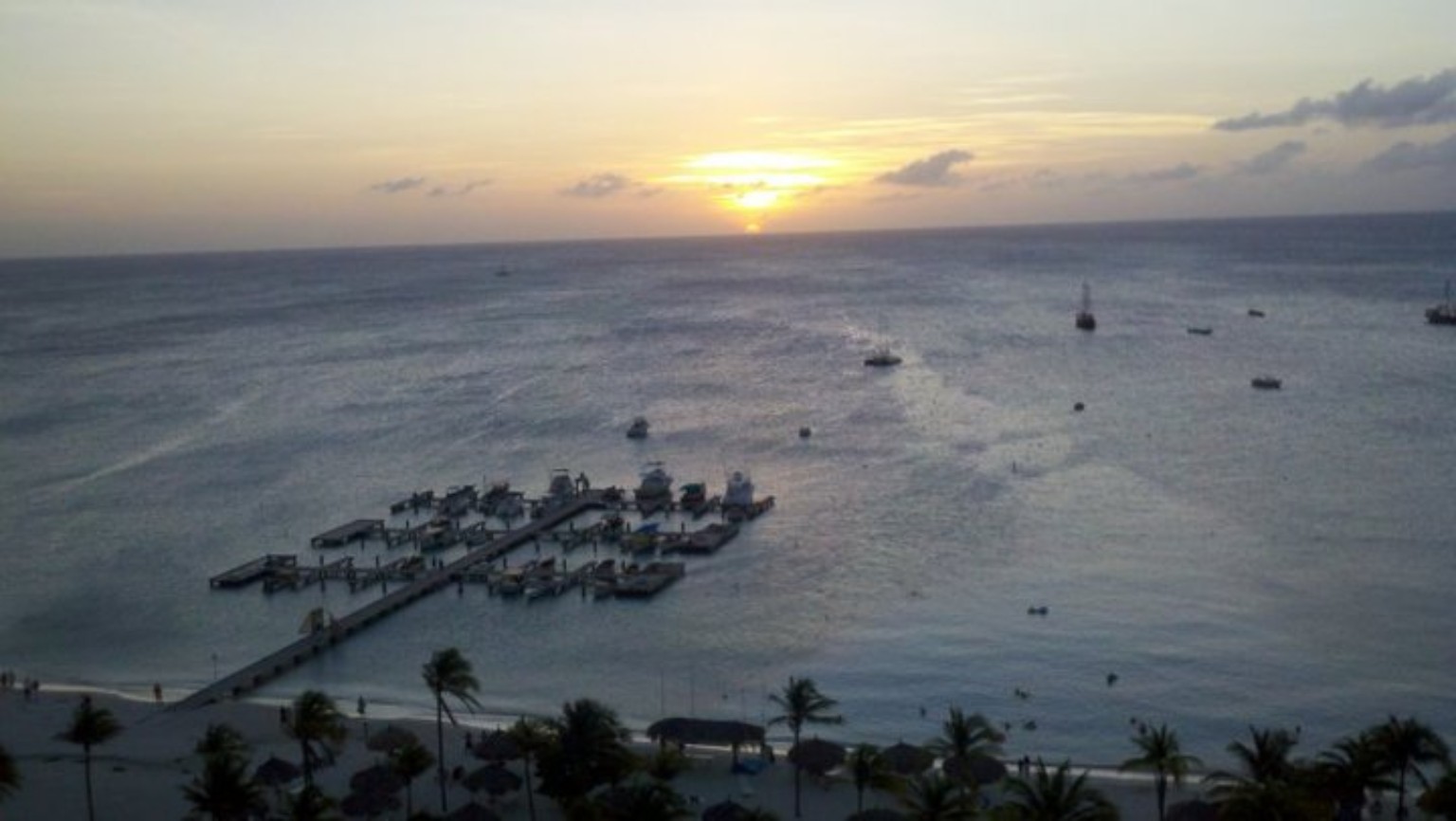 Sunset over a pier in Aruba