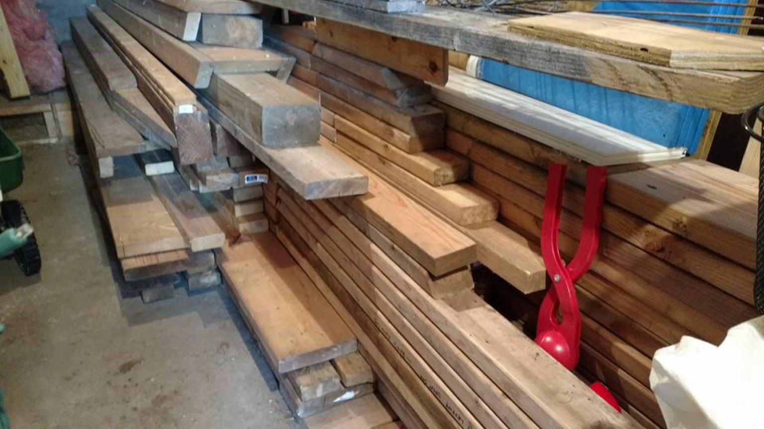 Stockpile of lumber in a garage for rink construction