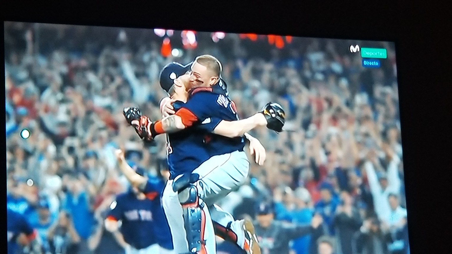 Red Sox players celebrating on a hotel TV in Barcelona