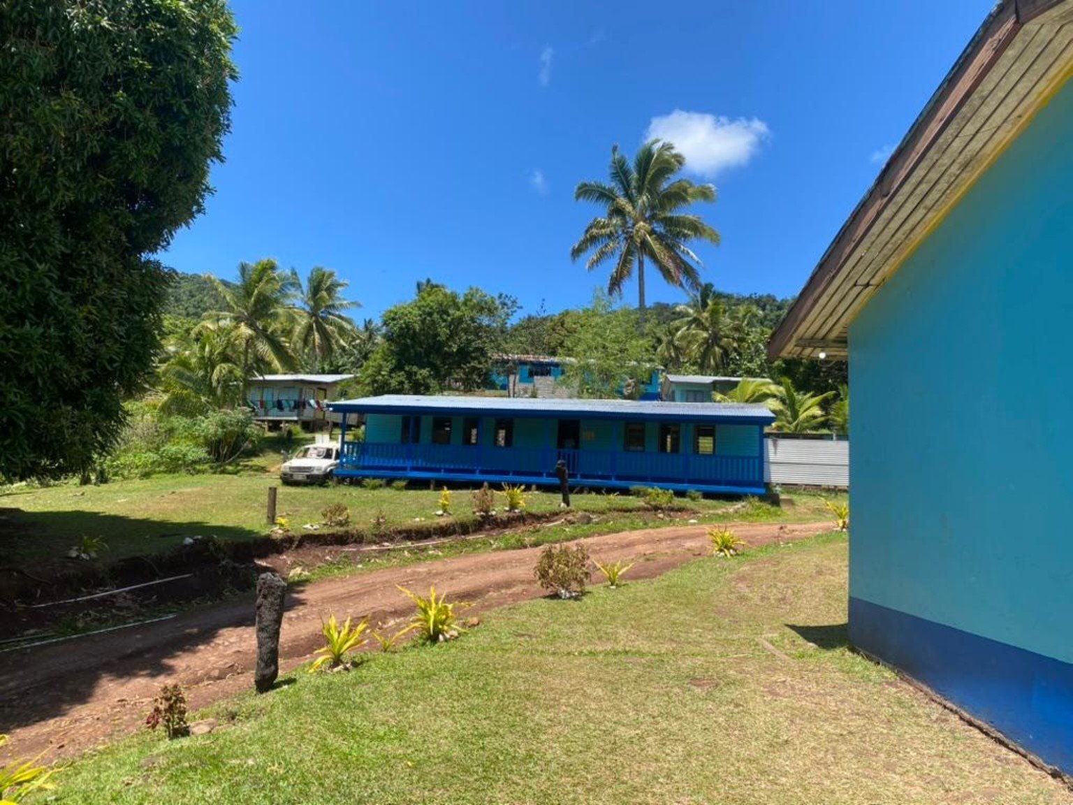 School and village setting on Kadavu with blue buildings and green hills