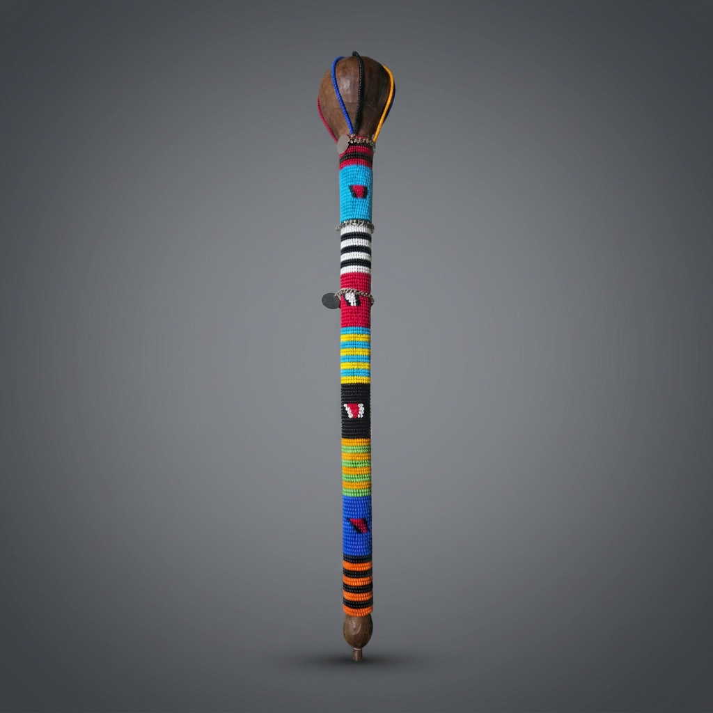Maasai beaded rungu ceremonial club from Kenya with hardwood knob head, tapered shaft wrapped in bright red, blue, yellow, green, orange, black and white beadwork, and small metal charms