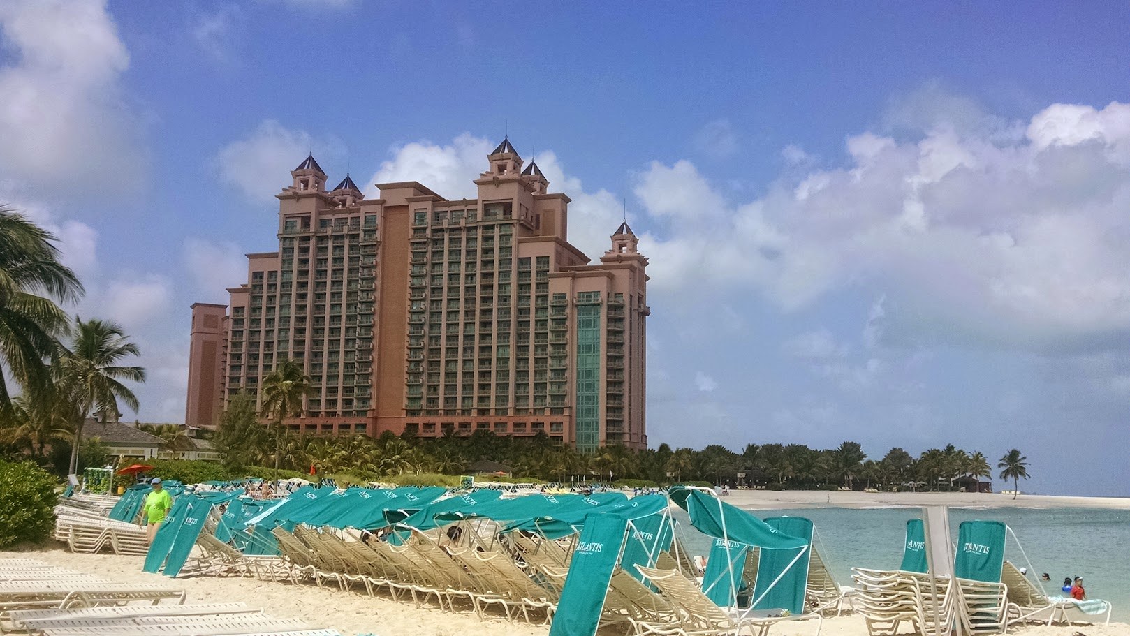 The Royal Towers framed by palms, pink stone, bridges and resort-scale ambition.