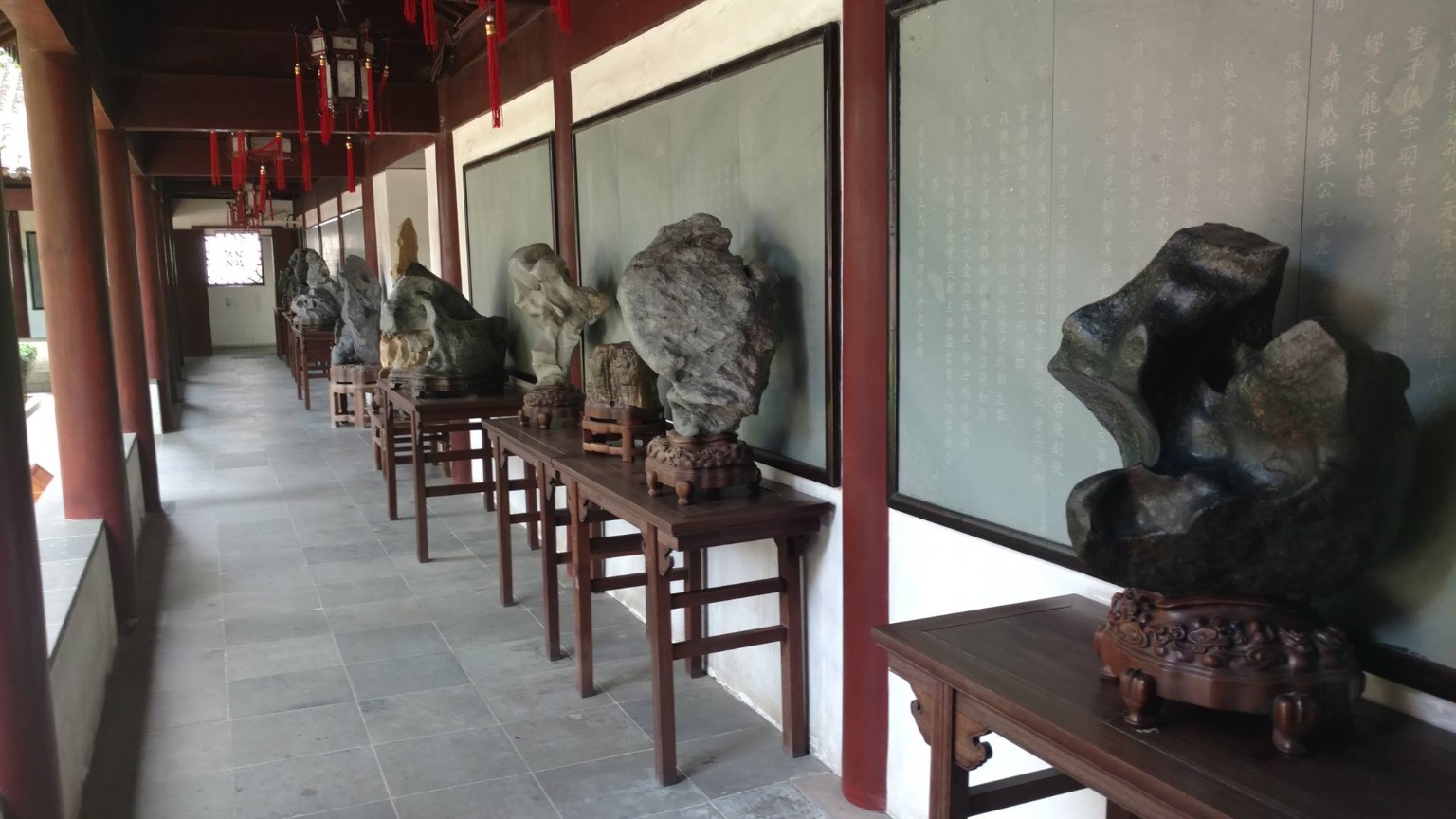 A gallery of dramatic scholar stones and carved wood displays